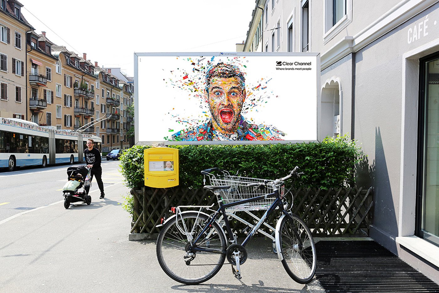  Clear Channel billboard in Switzerland – large-format logo mosaic portrait on city street.  