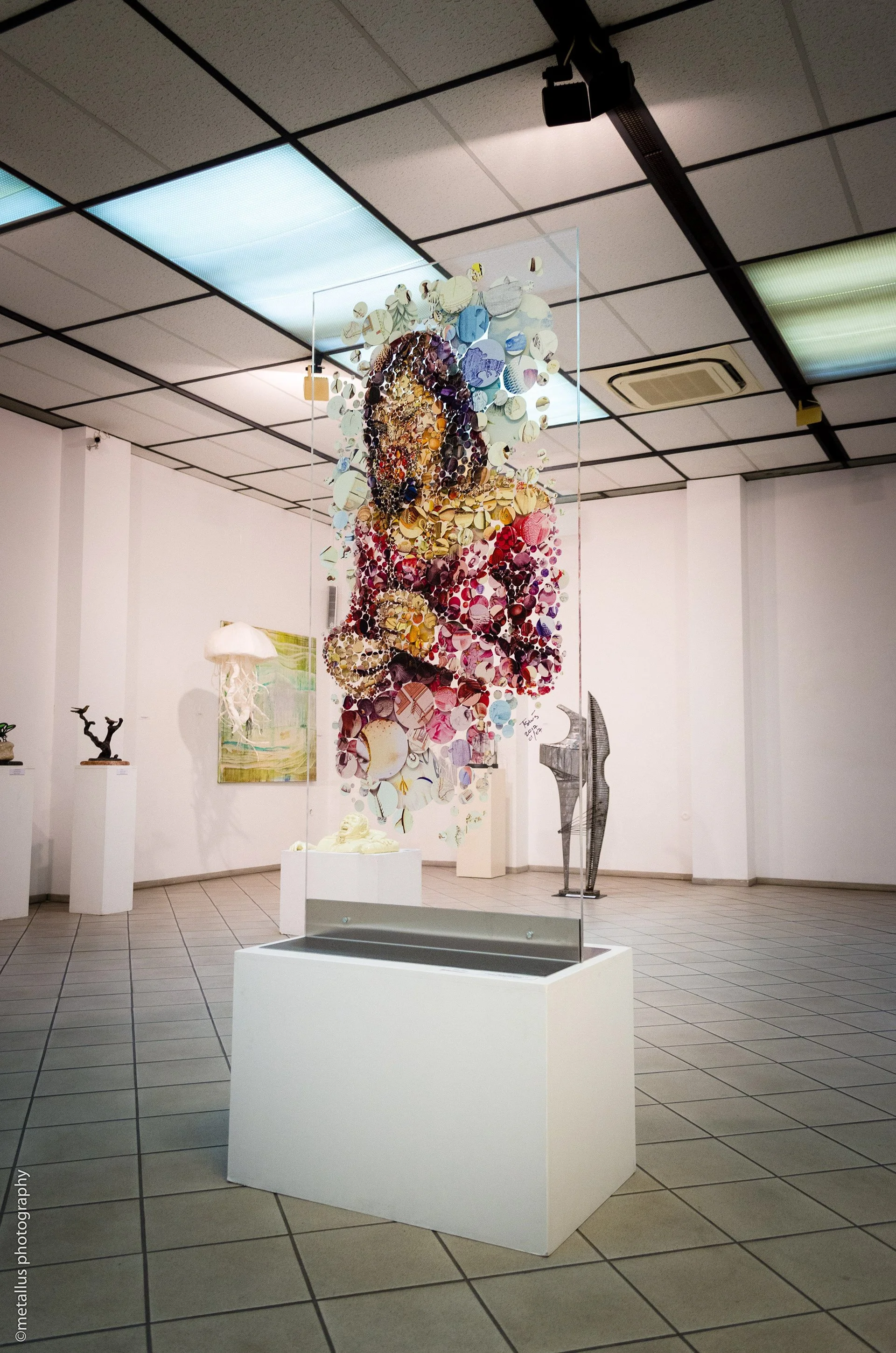   Exhibition photo – attendees viewing Two Roses double-sided mosaic at Thessaloniki gallery.  