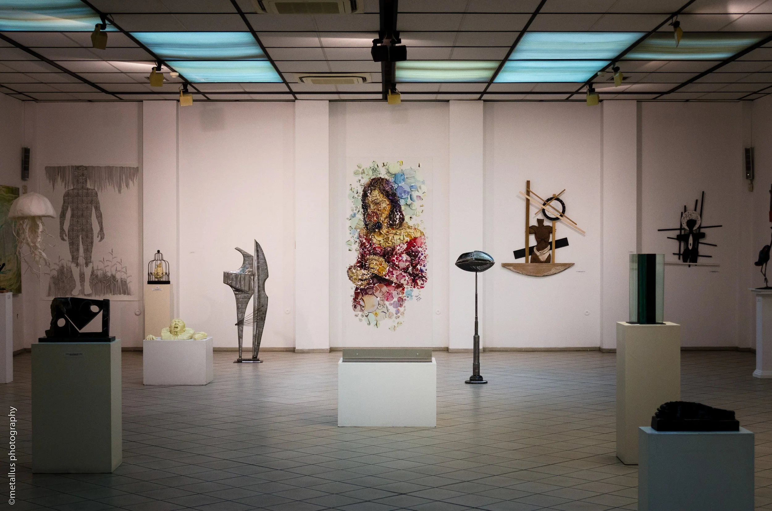   Exhibition photo – attendees viewing Two Roses double-sided mosaic at Thessaloniki gallery.  