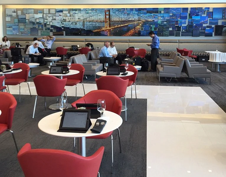 A long mosaic mural of the Golden Gate Bridge, day and night, on the wall of the Delta Sky Club at San Francisco airport