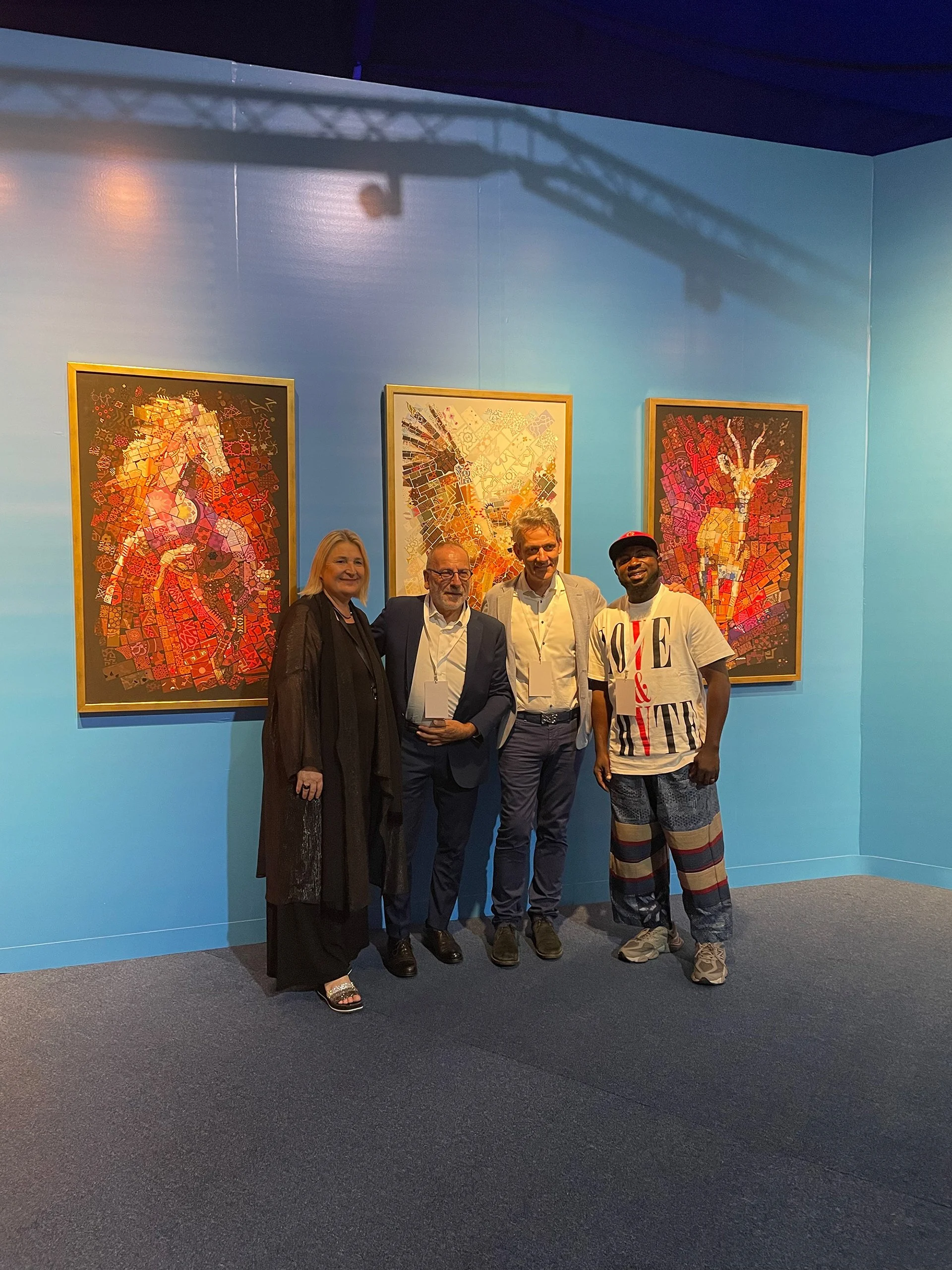tsevis-four-attendees-pose-before-mosaic-animal.jpg
