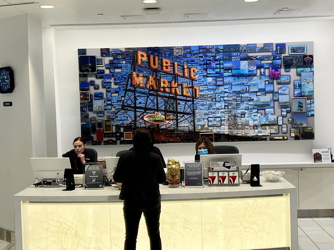 Mosaic wall behind the reception desk of the Delta SkyLounge in Seattle, built around the Public Market sign
