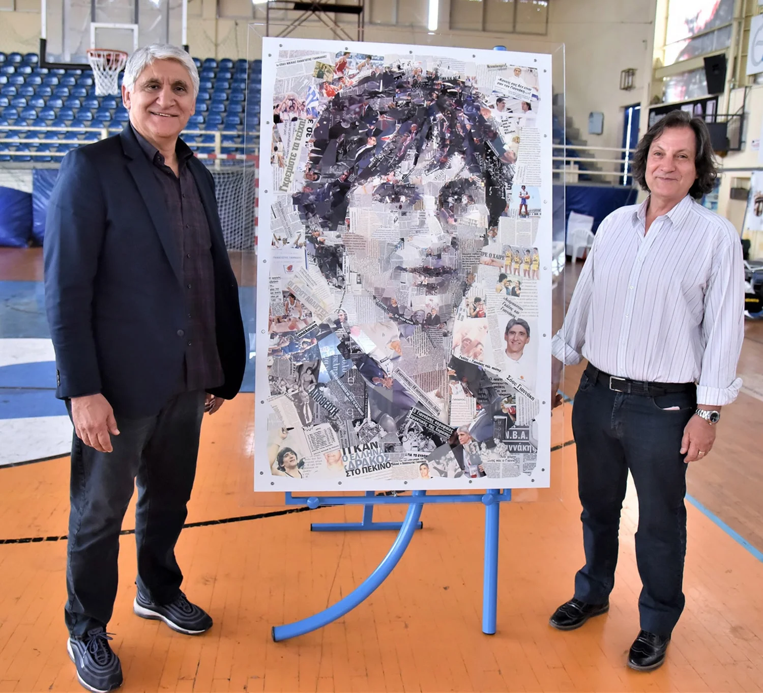 Legendary Greek basketball player and coach Panagiotis Giannakis, alongside Takis Kaloudis, President of the Hellenic Wheelchair Basketball Federation, pose with a mosaic portrait of Giannakis.