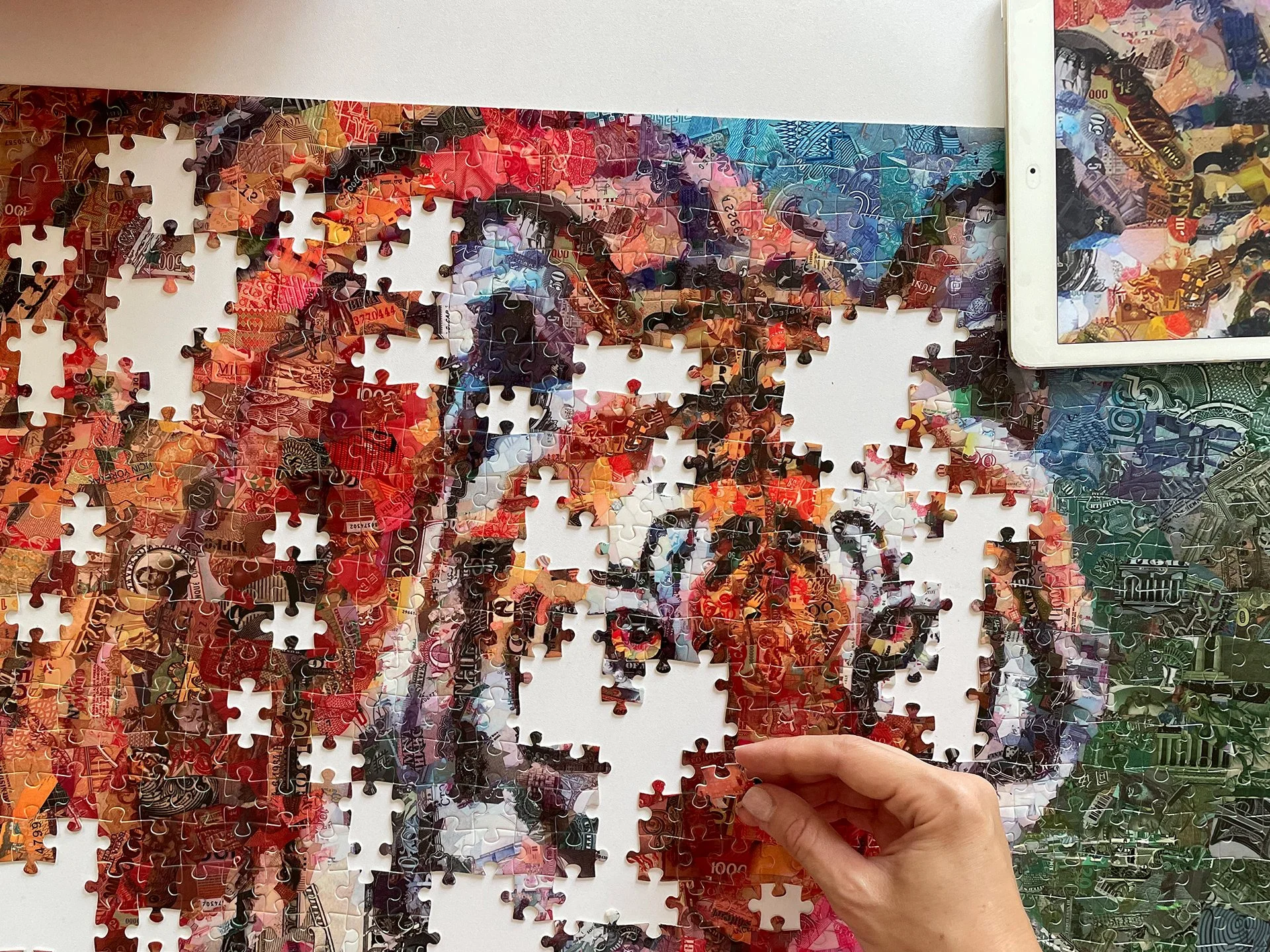 tsevis-hand-placing-1000-note-colorful-puzzle.jpg