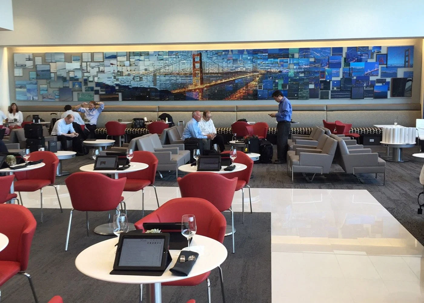 Delta SkyLounge in San Francisco with a Golden Gate Bridge mosaic wall behind the seating