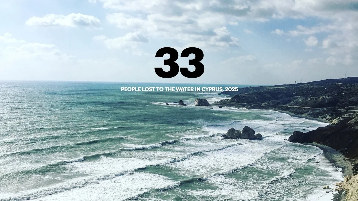 A rocky Cypriot coastline with waves breaking on the shore under a cloudy sky, and the number 33 above the words “people lost to the water in Cyprus, 2025”.