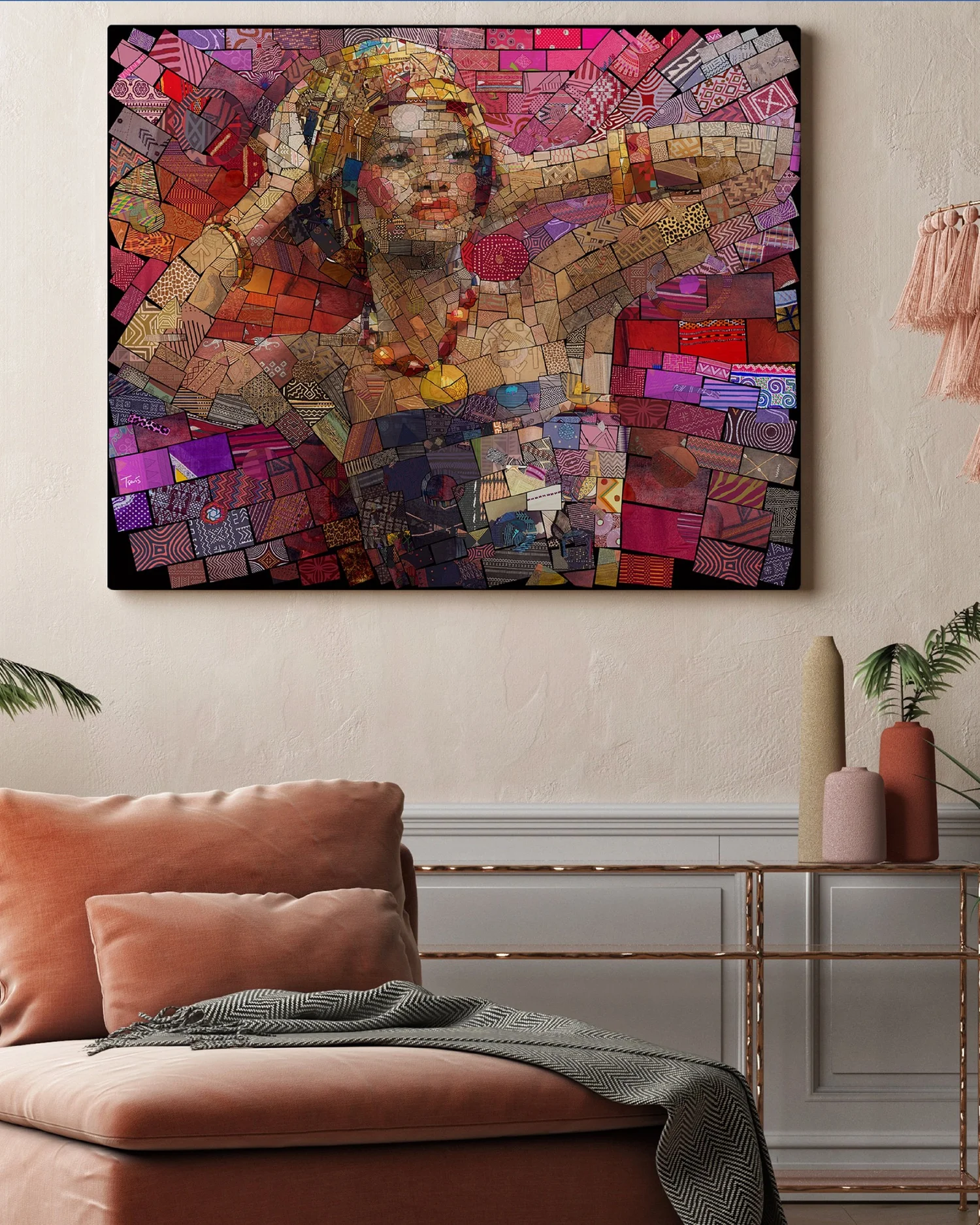 Mosaic of a woman with raised arms, gold headpiece and beads in pink tones, shown framed above a salmon-colored sofa
