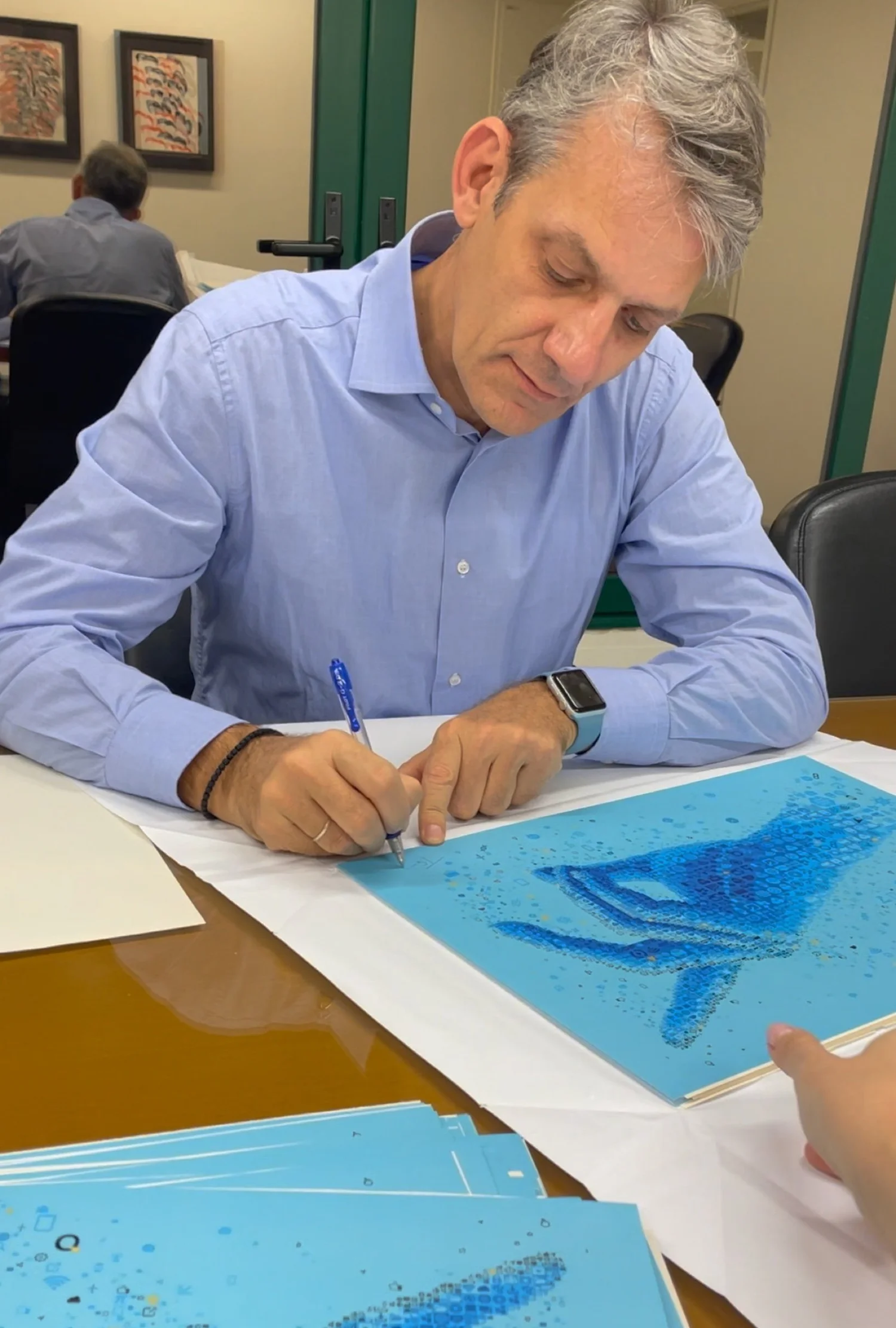 Signing custom corporate gifts as exclusive art prints