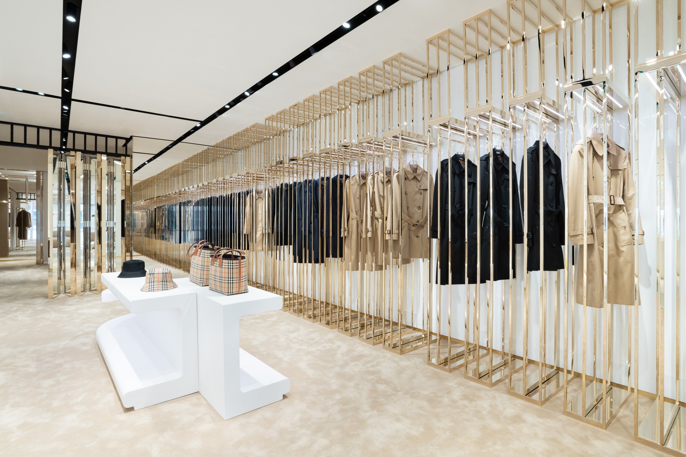 Showroom at Burberry Bond Street, with displays of bags, hats and coats.