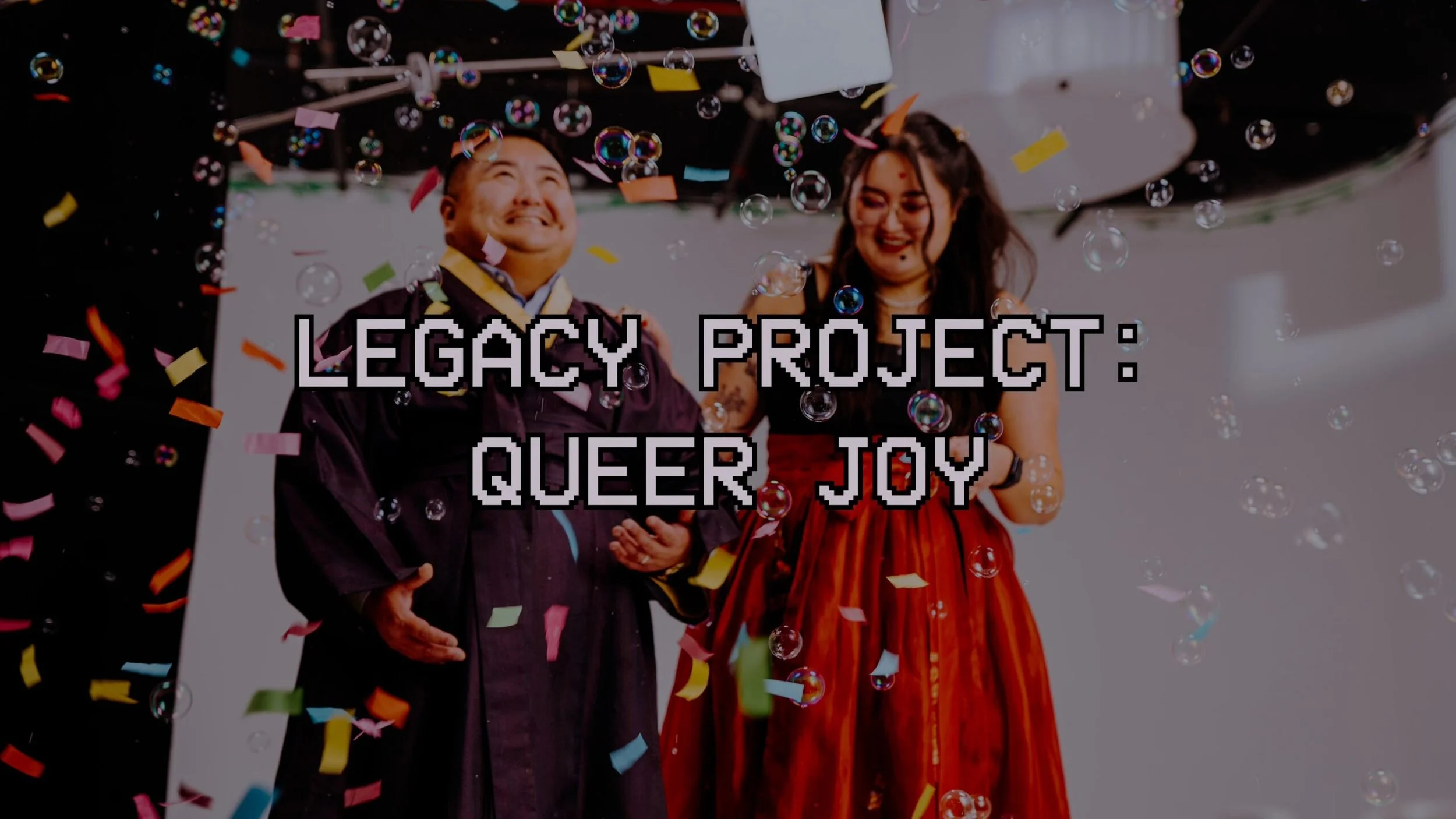 Two people in formal attire celebrating among falling colorful confetti and bubbles, with text overlay reading 'Legacy Project: Queer Joy'.