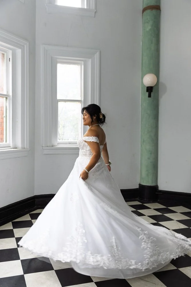 Khristy beside a window before her Richmond wedding.