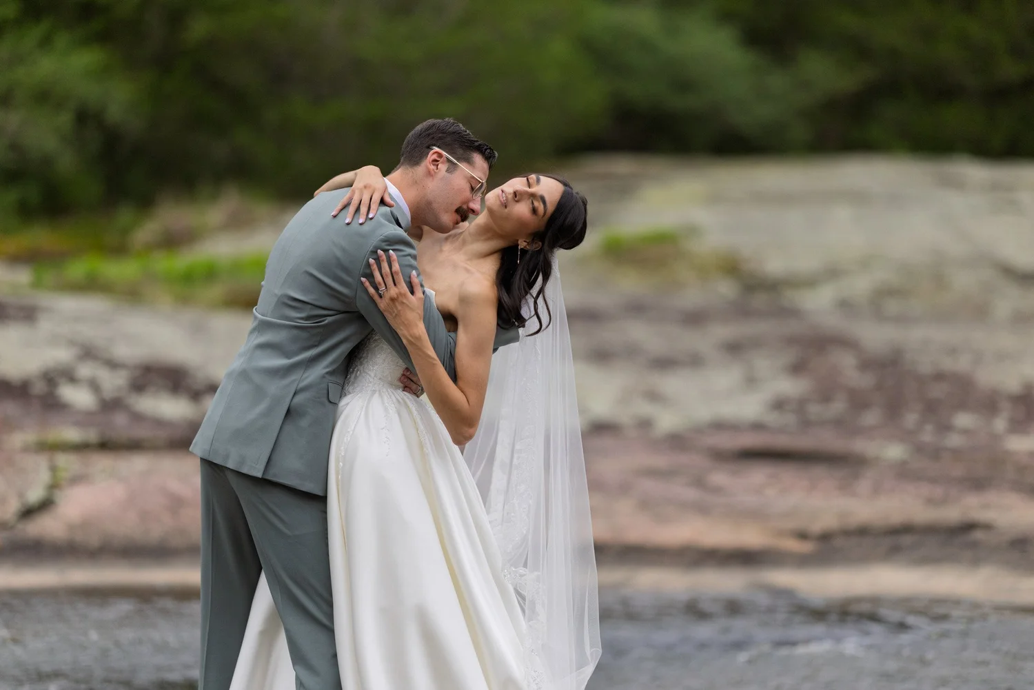 Jenai and Michael sharing a creekside wedding portrait at The Mill at Fine Creek in Powhatan, Virginia.