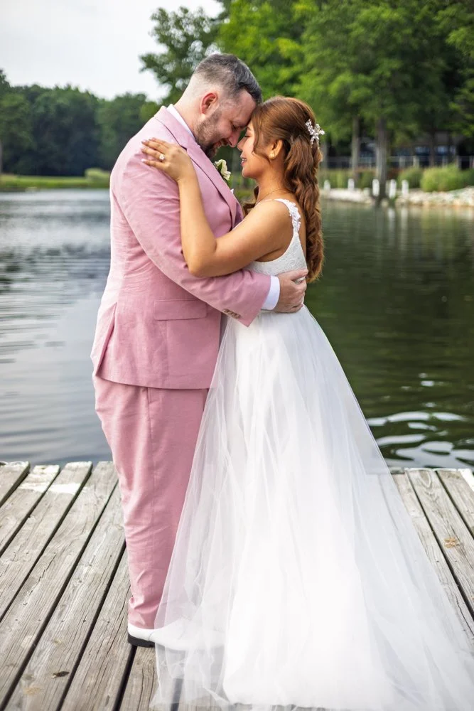 Camille and Kevin together beside the water on their wedding day.