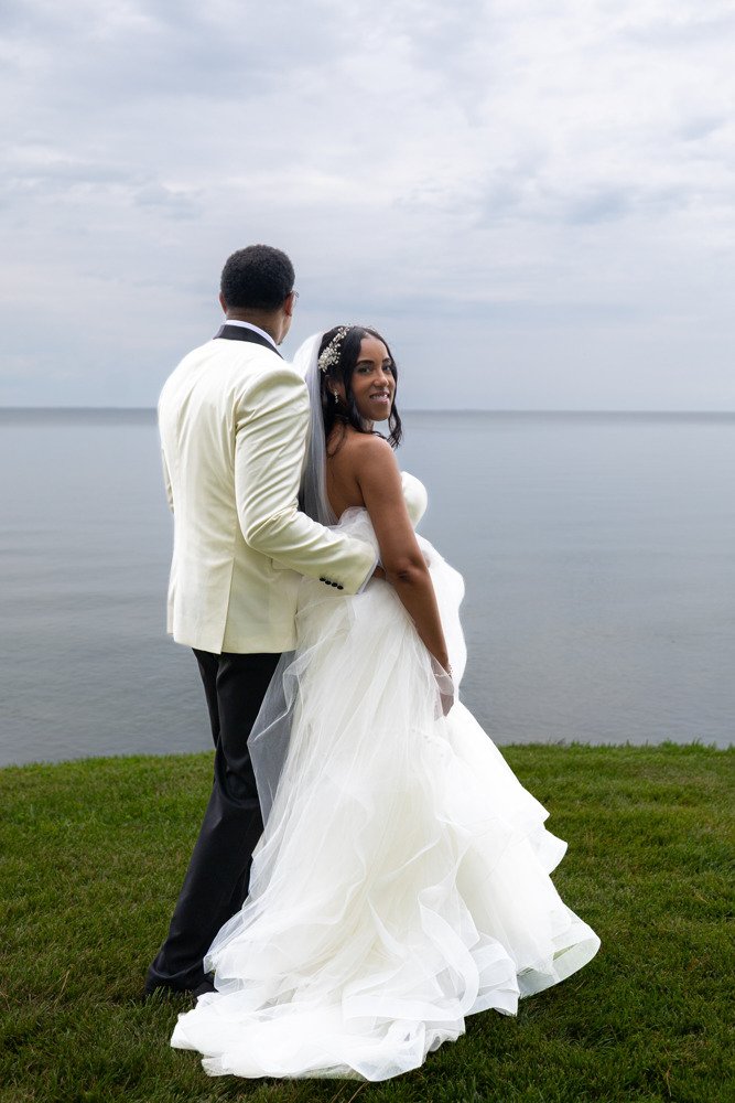 Ashley and Marcus sharing a waterfront wedding portrait.