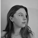 Black and white photo of a young woman with long hair, looking to the side.