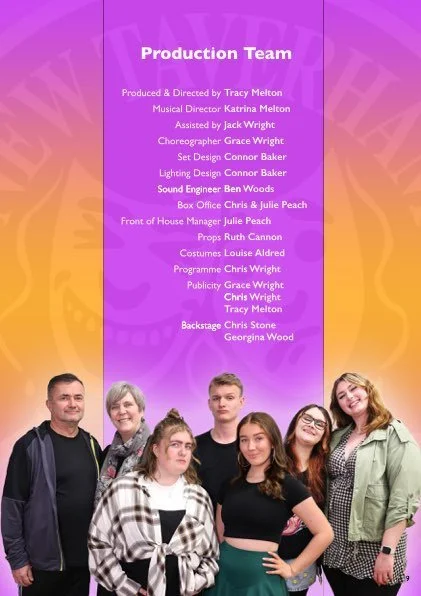Group photo of six people standing in front of a colorful, purple and yellow background with creative arts production team credits, including production staff and cast members.