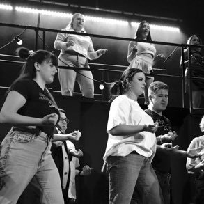 Group of women standing in a boxing ring, practicing or preparing for a boxing match.