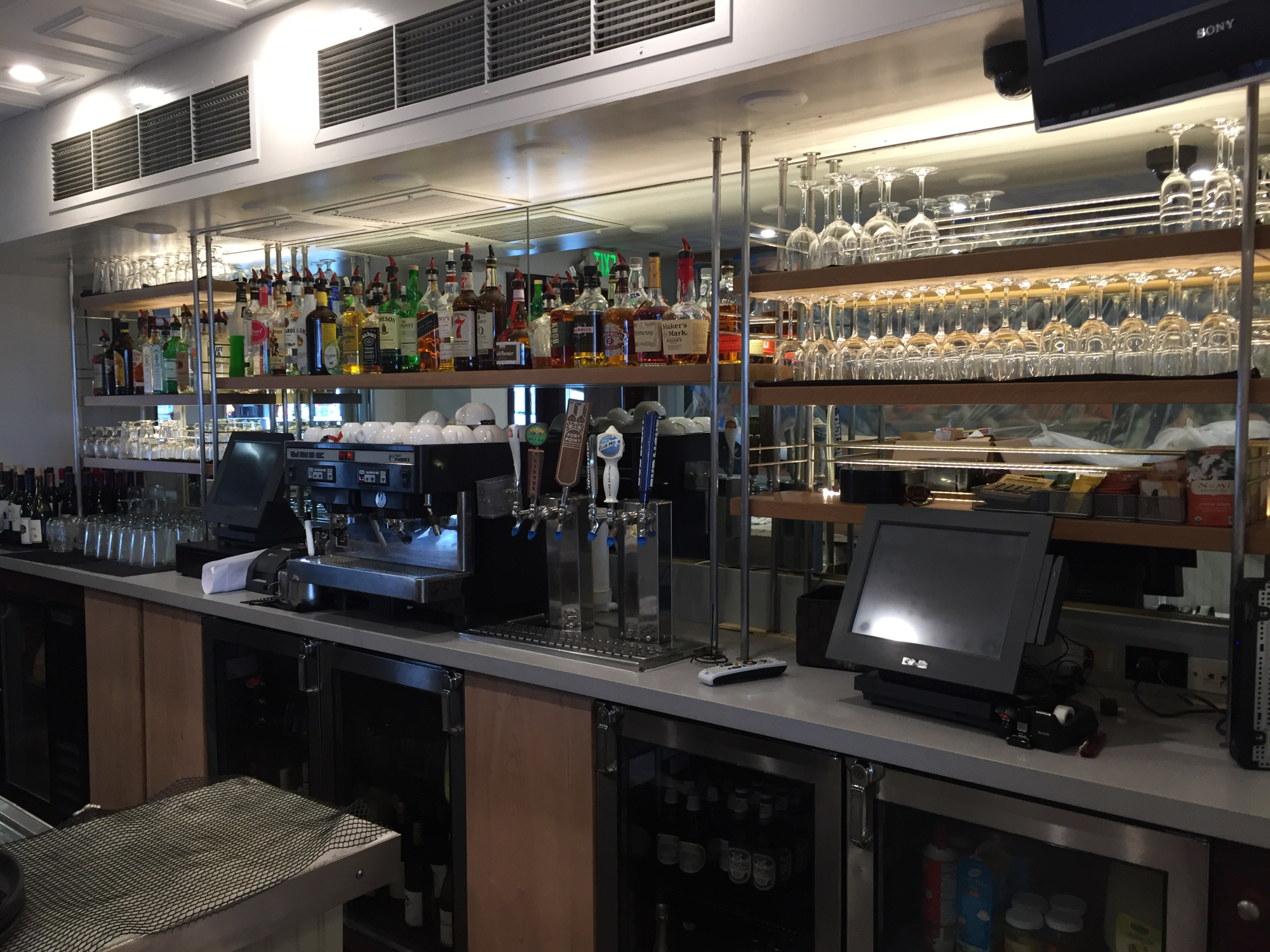 Custom made bar shelving for hanging glasses from behind a bar area.