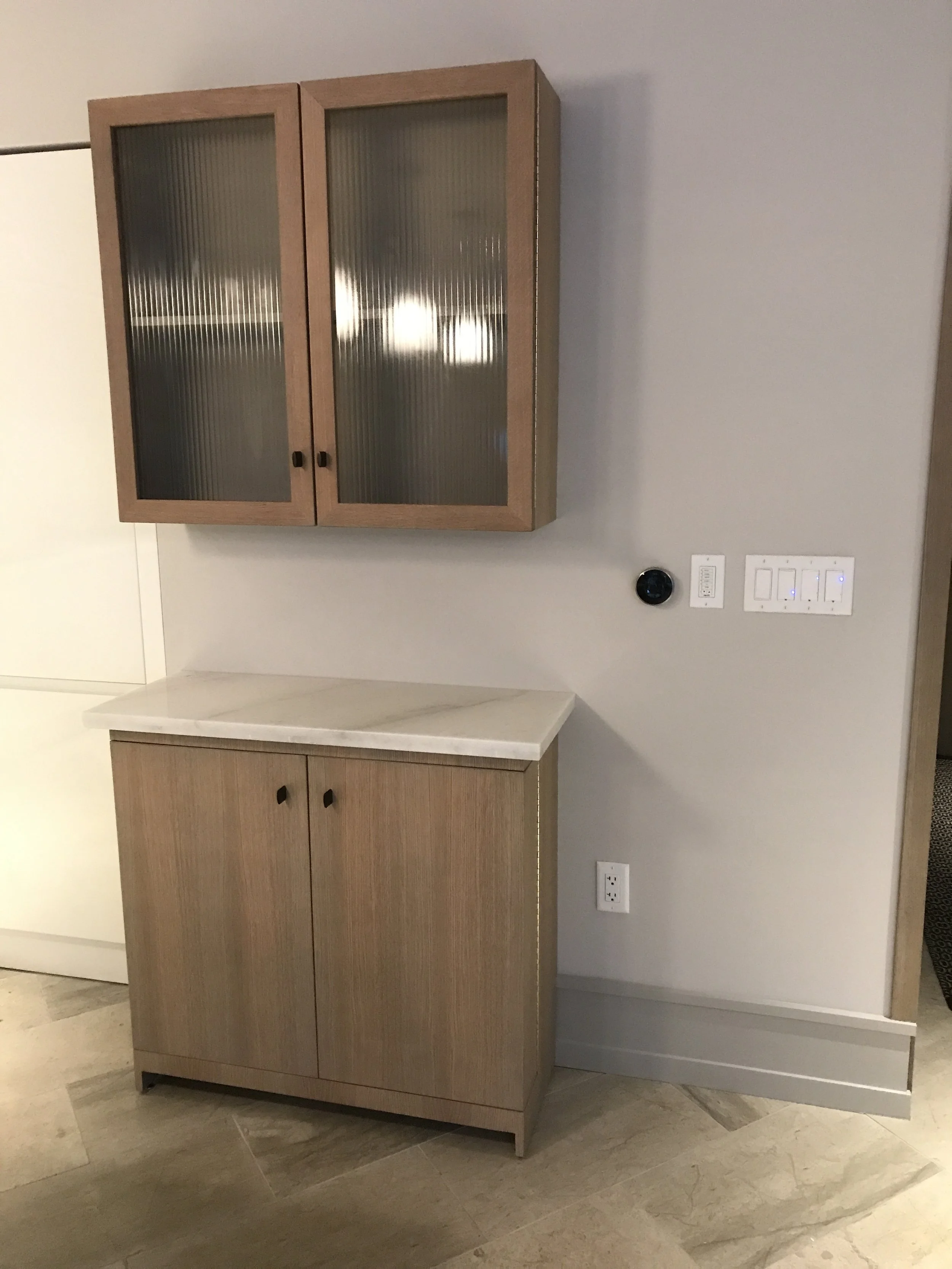 A custom made wall cabinet and floor cupboard in a residential kitchen.