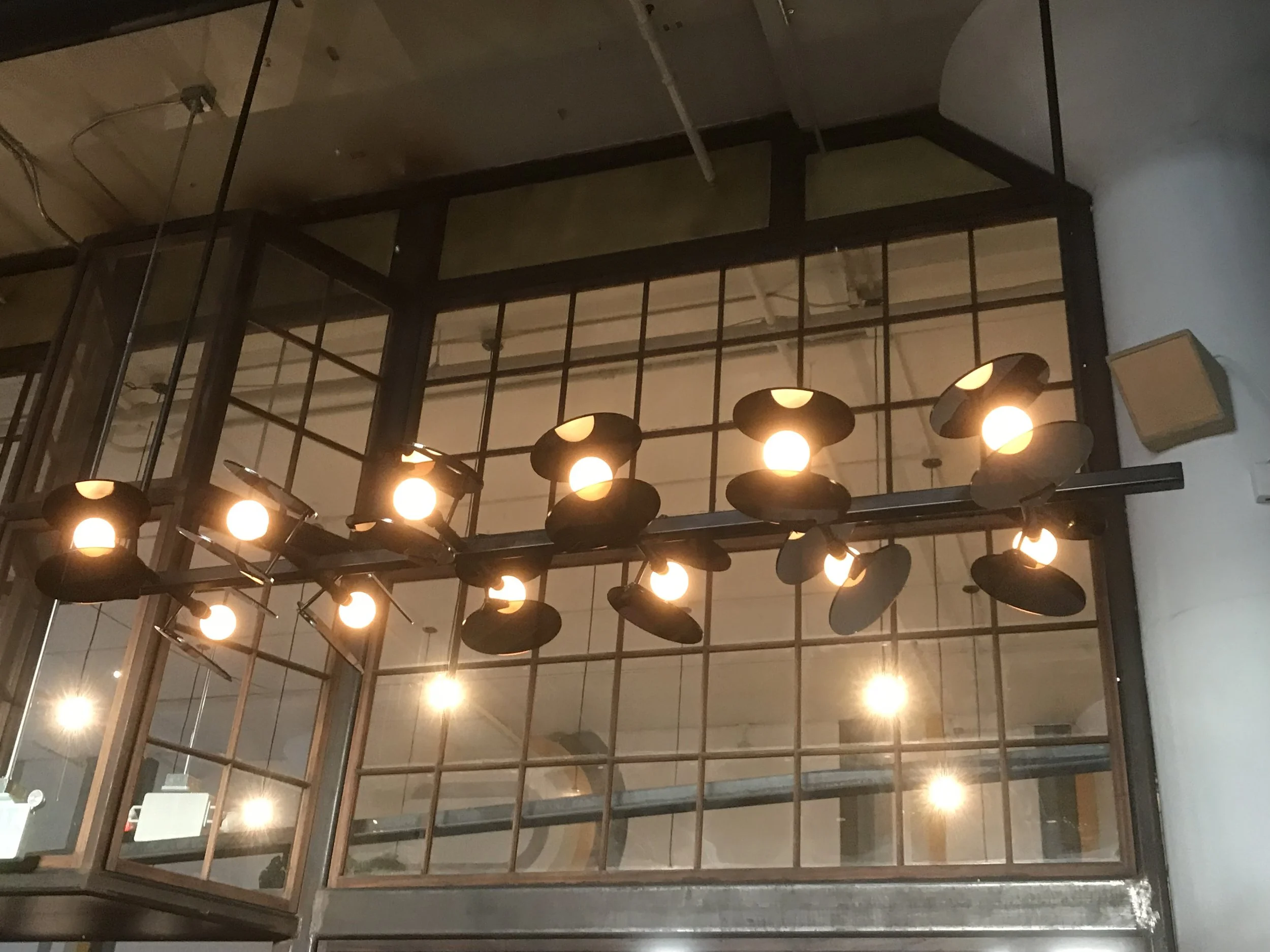 Close up shot of the hour glass shaped lights hanging from the roof.
