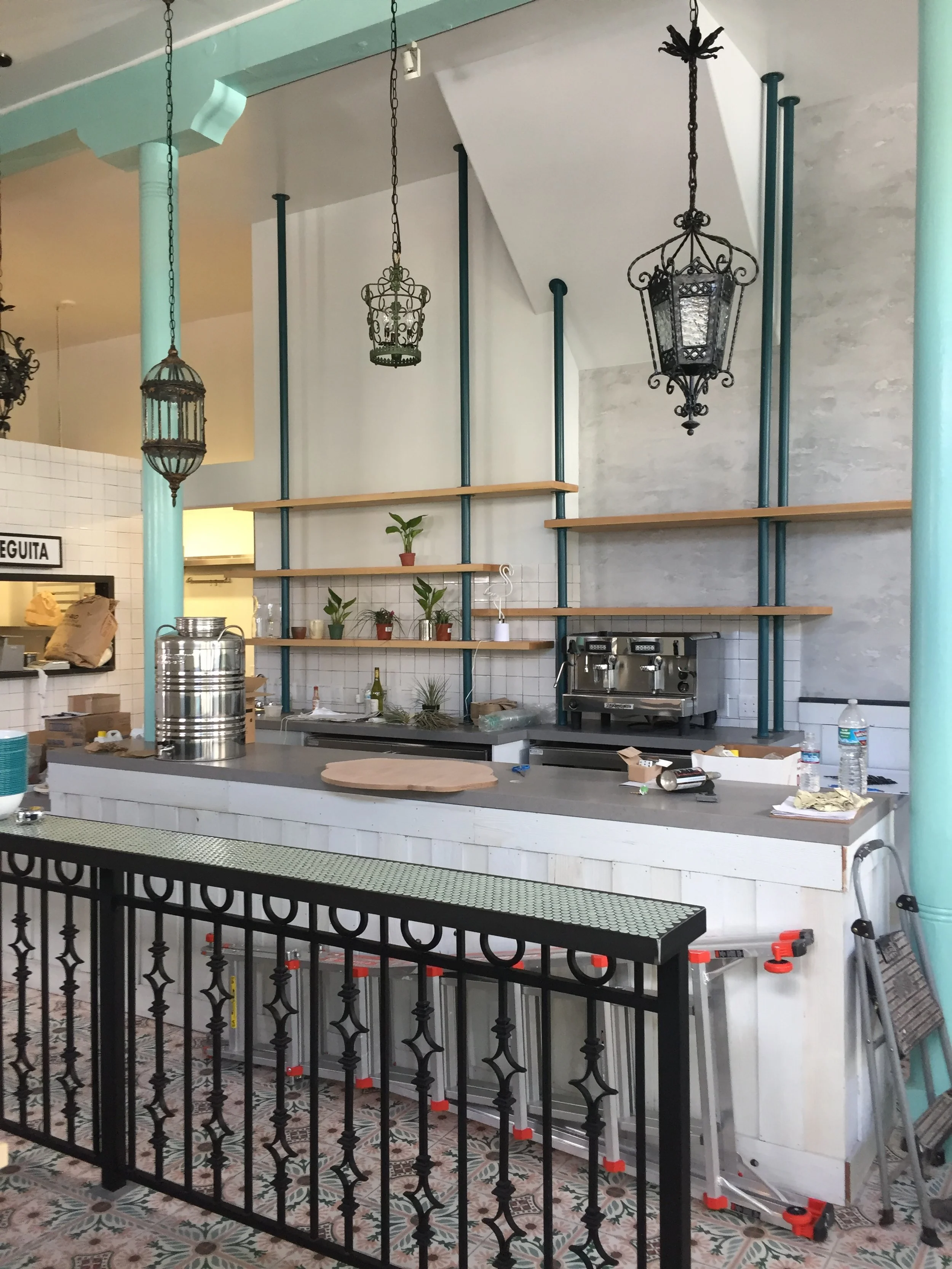 A far away shot of multi layered wooden shelving for a restaurant with an awkward shaped roof.
