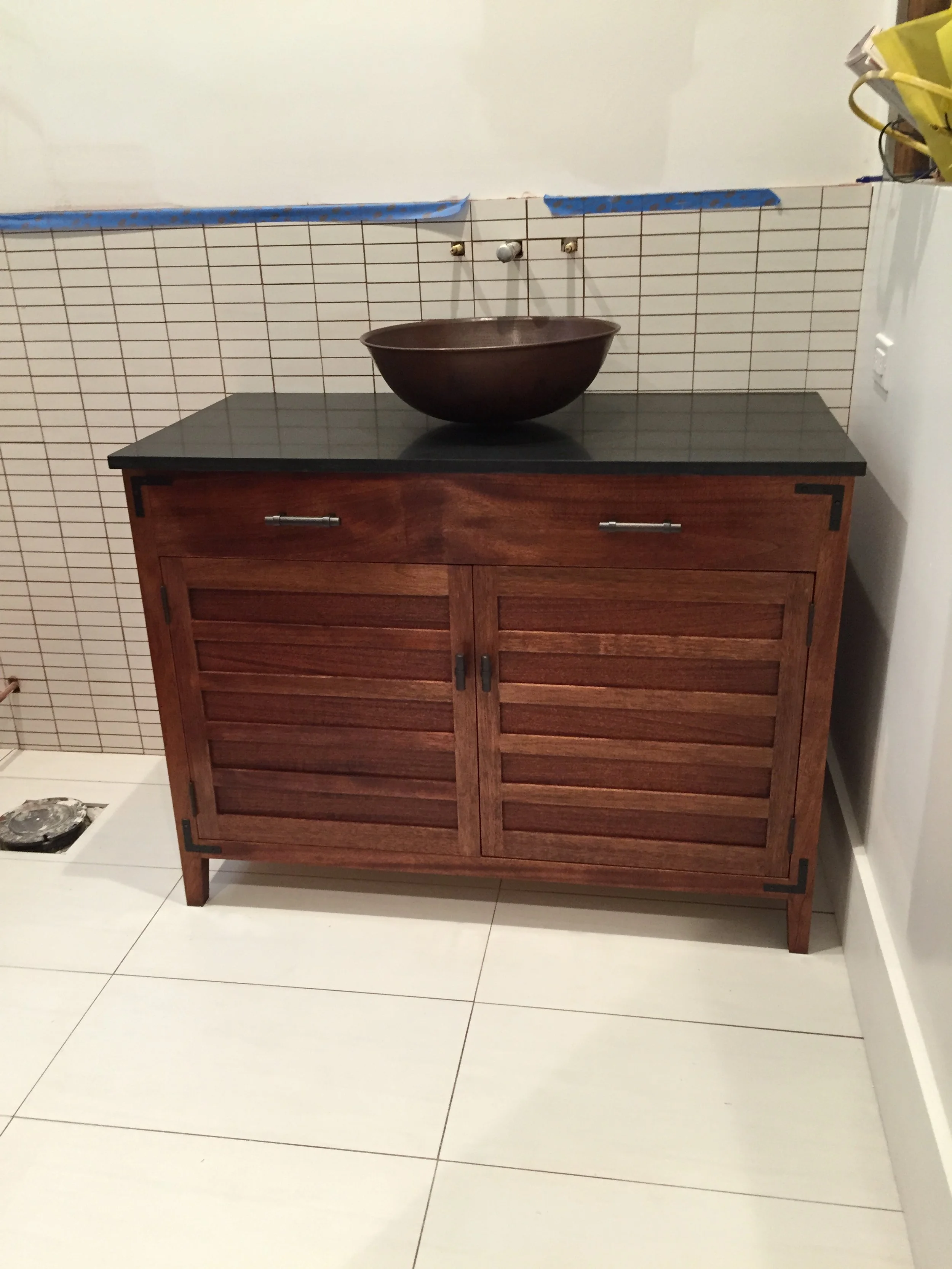 Custom build sink cupboards with drawers and a stripped door design.