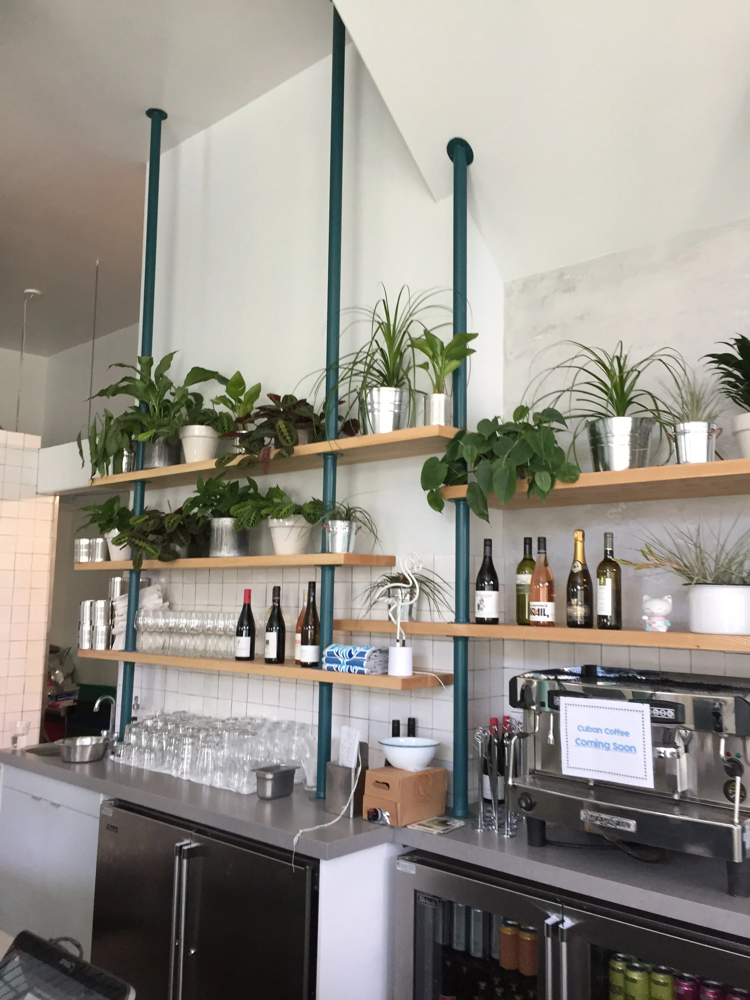 A close up shot of multi layered wooden shelving for a restaurant with an awkward shaped roof.