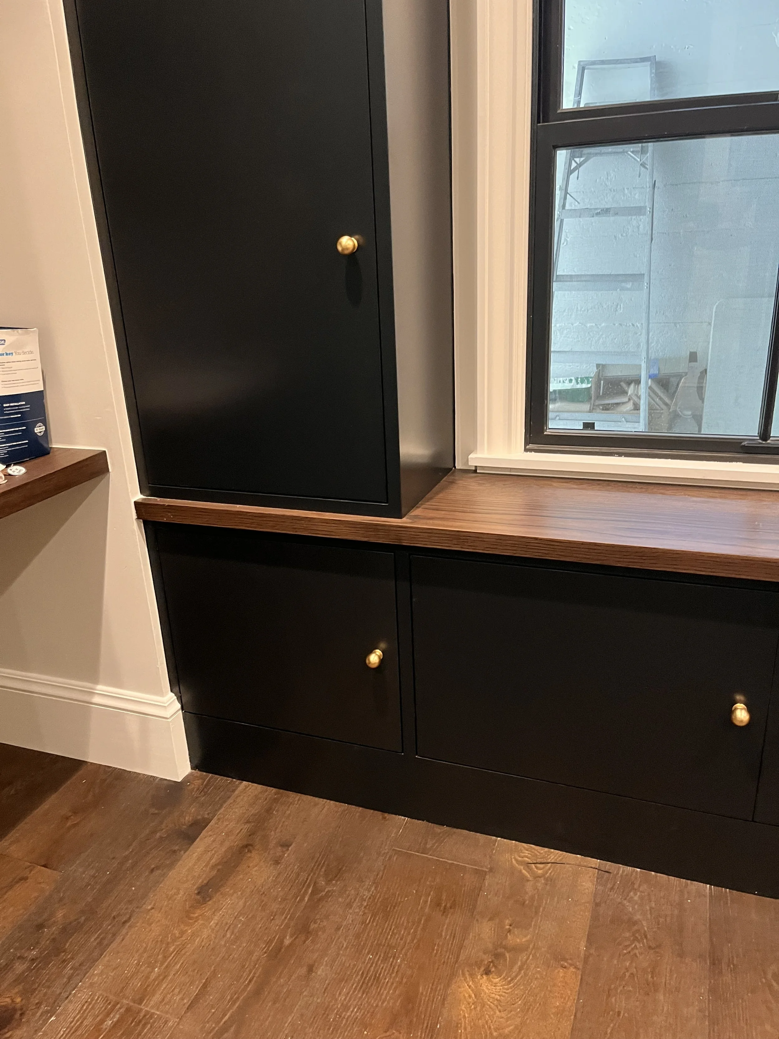 3 cupboards in an L shape around the window.
