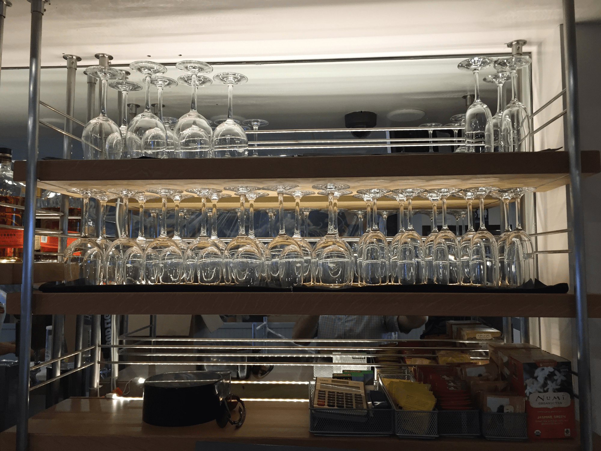 Close in shot of custom built bar shelving for hanging glasses.