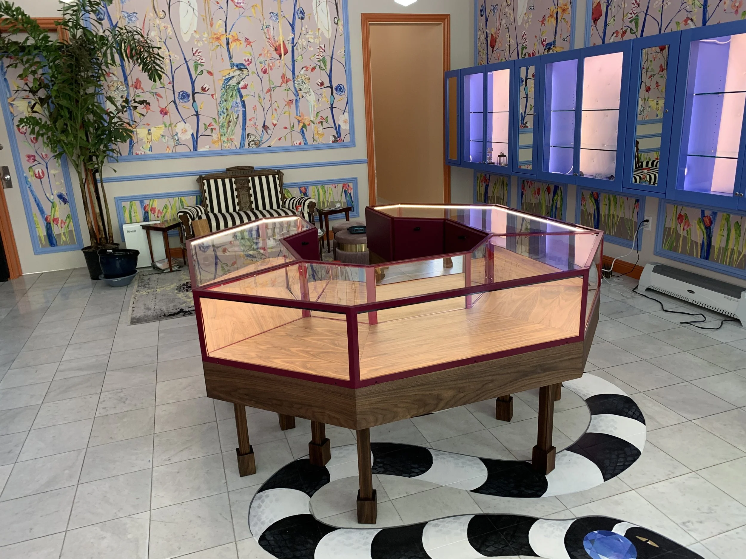 Octagon display case for a jewellery shop placed in the centre of the room.