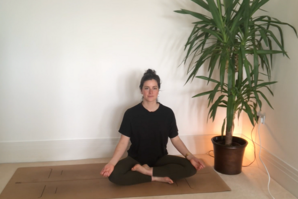 Harriett sat cross legged in a yoga pose