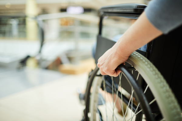 a close up view of a female hand on a wheelchair