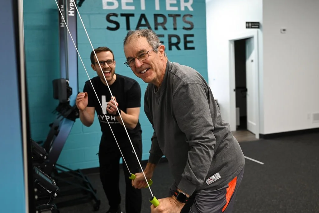 Man that's 60+ working with a physical therapist during a session at Hyphen fitness & physical therapy in Georgetown, KY.