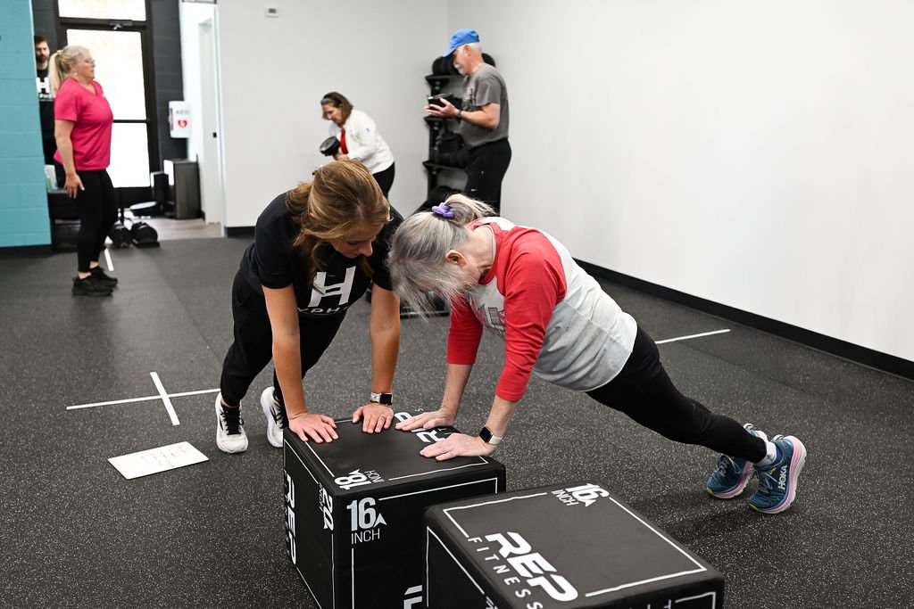 Group of people 60+ and trainers at Hyphen in Georgetown KY, smiling after a senior fitness class focused on strength, balance, and healthy aging.