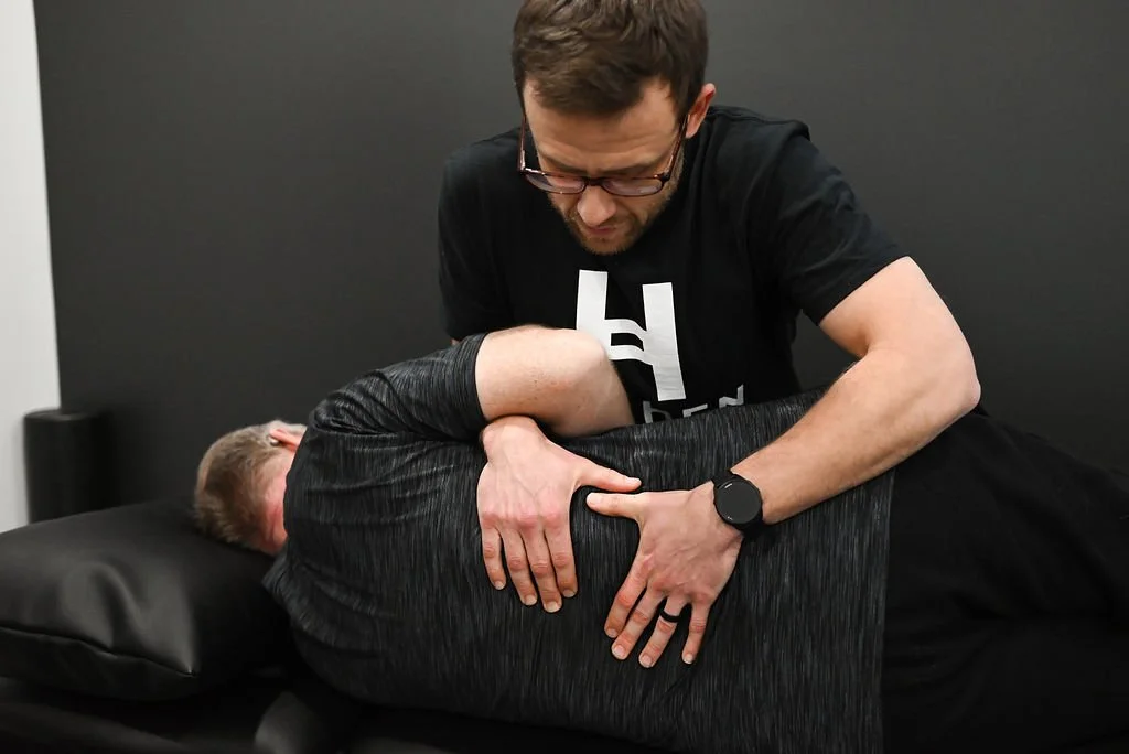 Physical therapist at Hyphen coaching a woman 60+ through a safe strength training exercise with a weighted ball—part of a personalized fitness program in Georgetown KY.