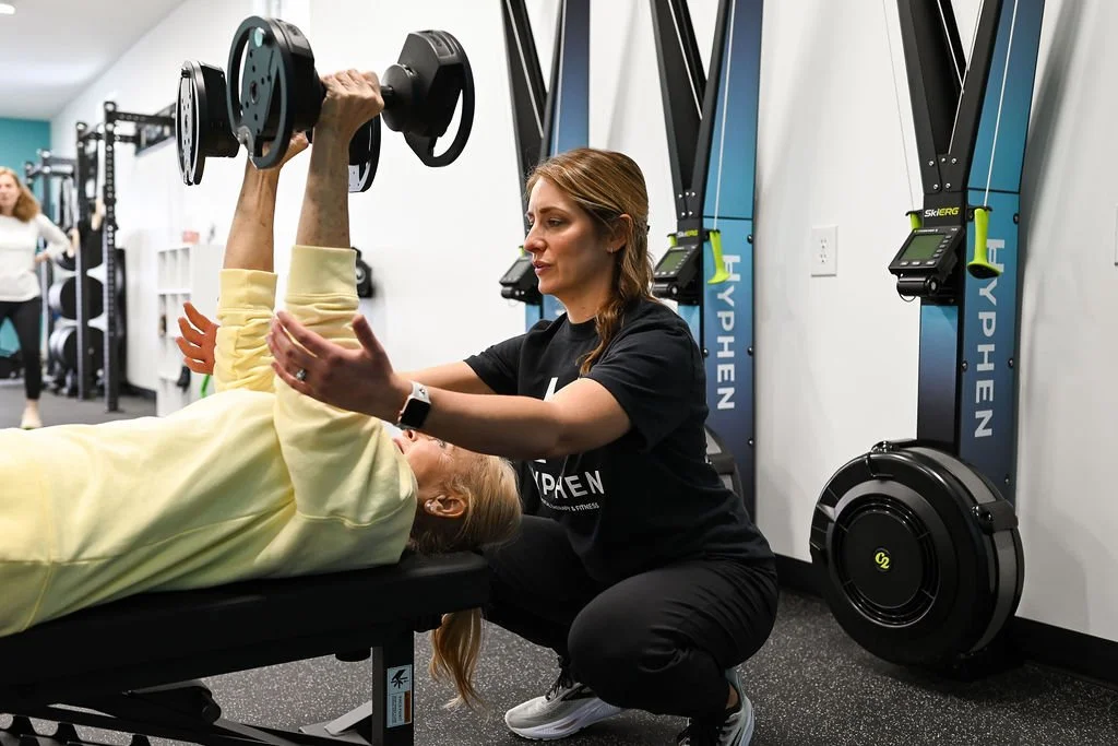 Physical Therapist helping a senior improve their arm strength.