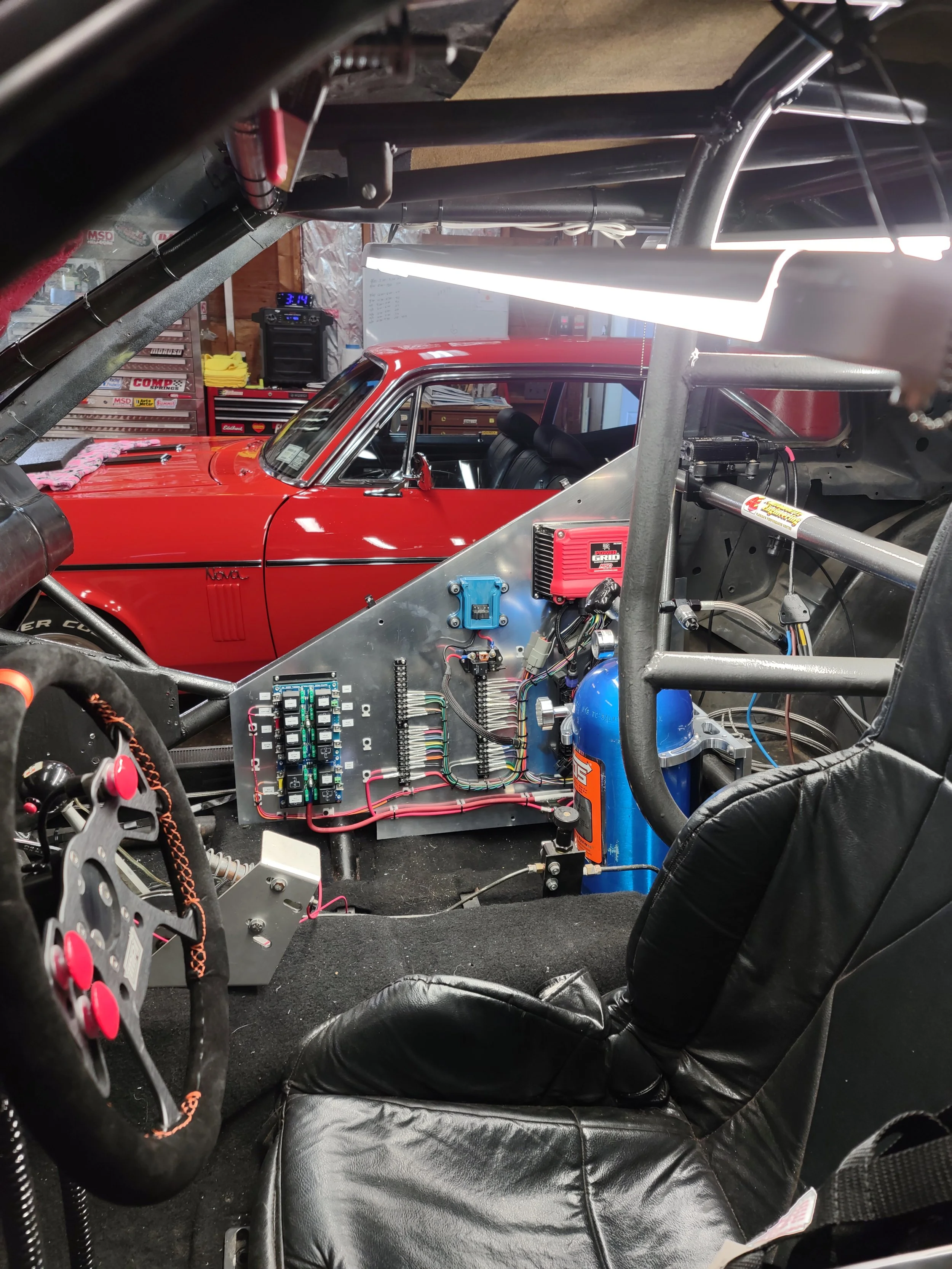 Custom fabricated control panel in a no prep  Mustang. Utilizing an MSD Grid, NX Nitrous Controller, K&R Switch Panel and Relay Board