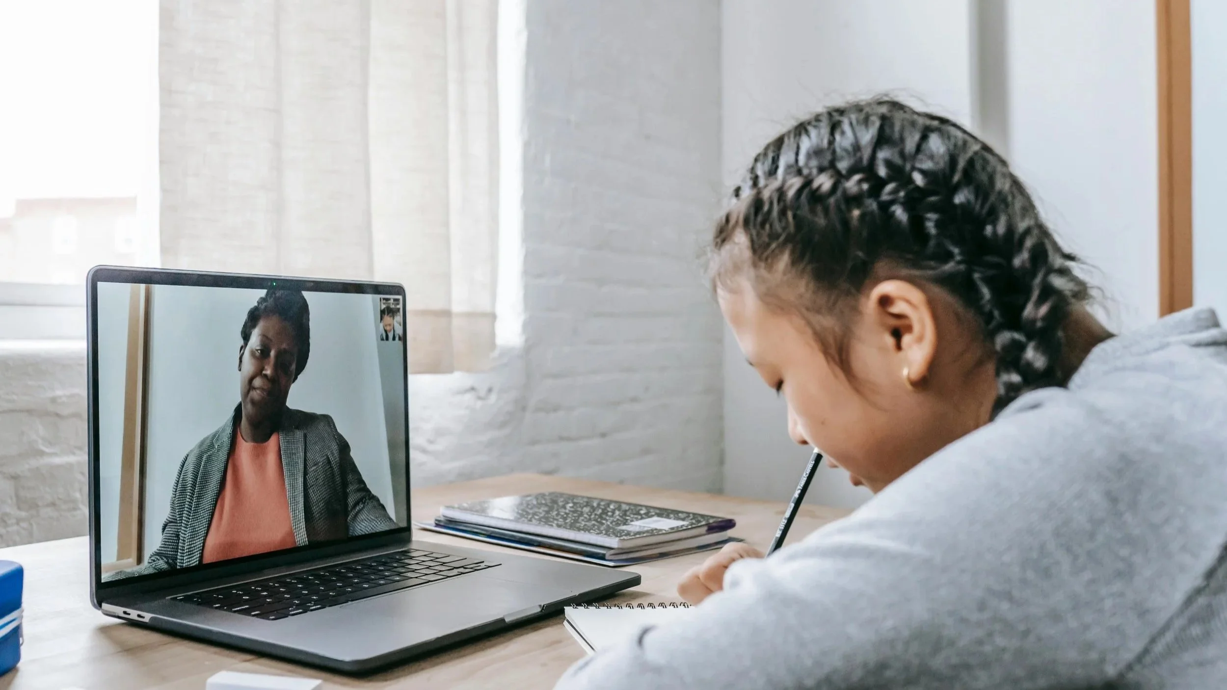 Online tutor teaching student through video lesson