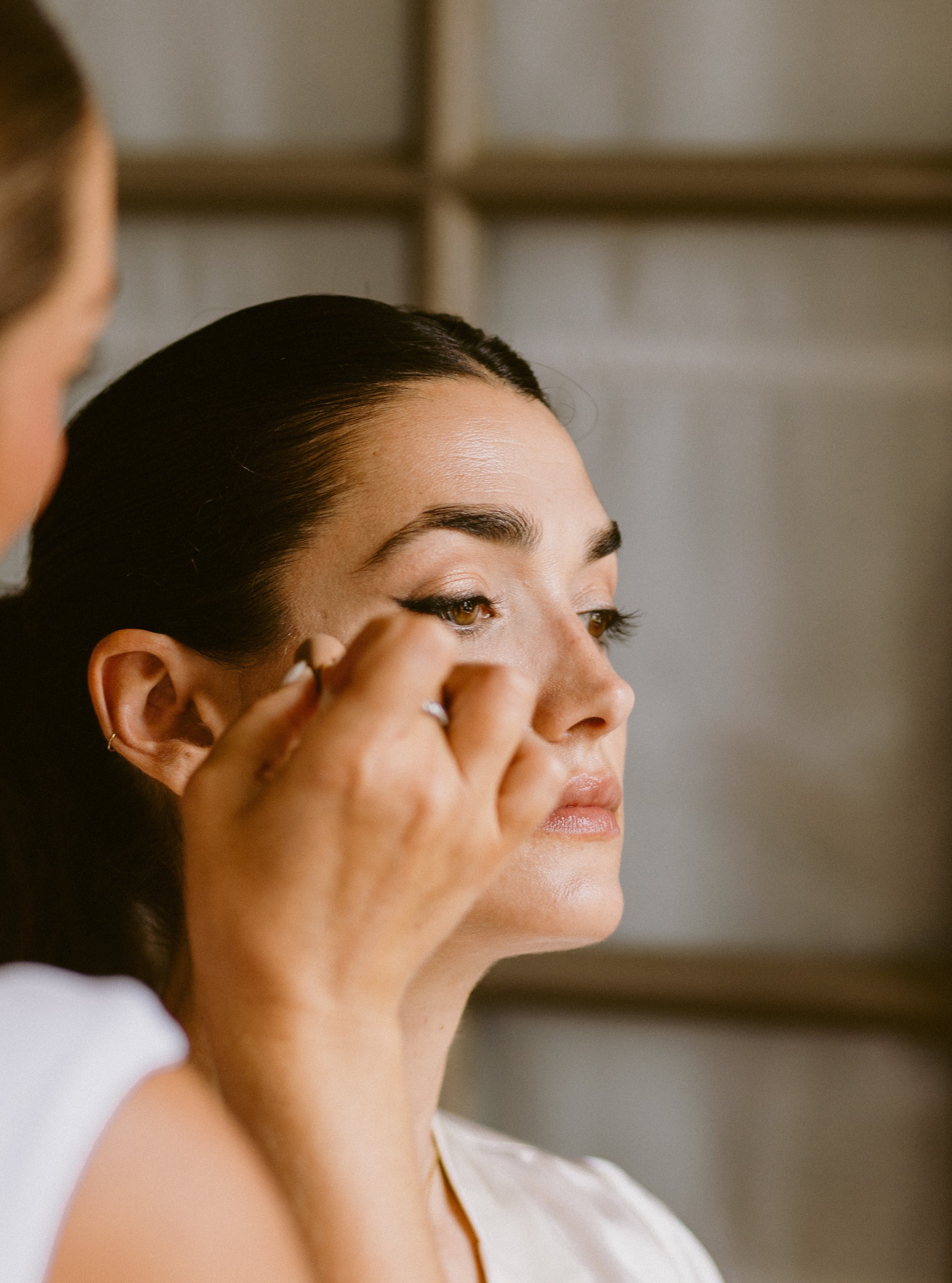 The bridal morning.

Lucile, looking absolutely stunning in those quiet hours before the ceremony.

Hair and makeup, a beautiful dress waiting nearby, music in the background and your favourite people in the room. There is something so special about 