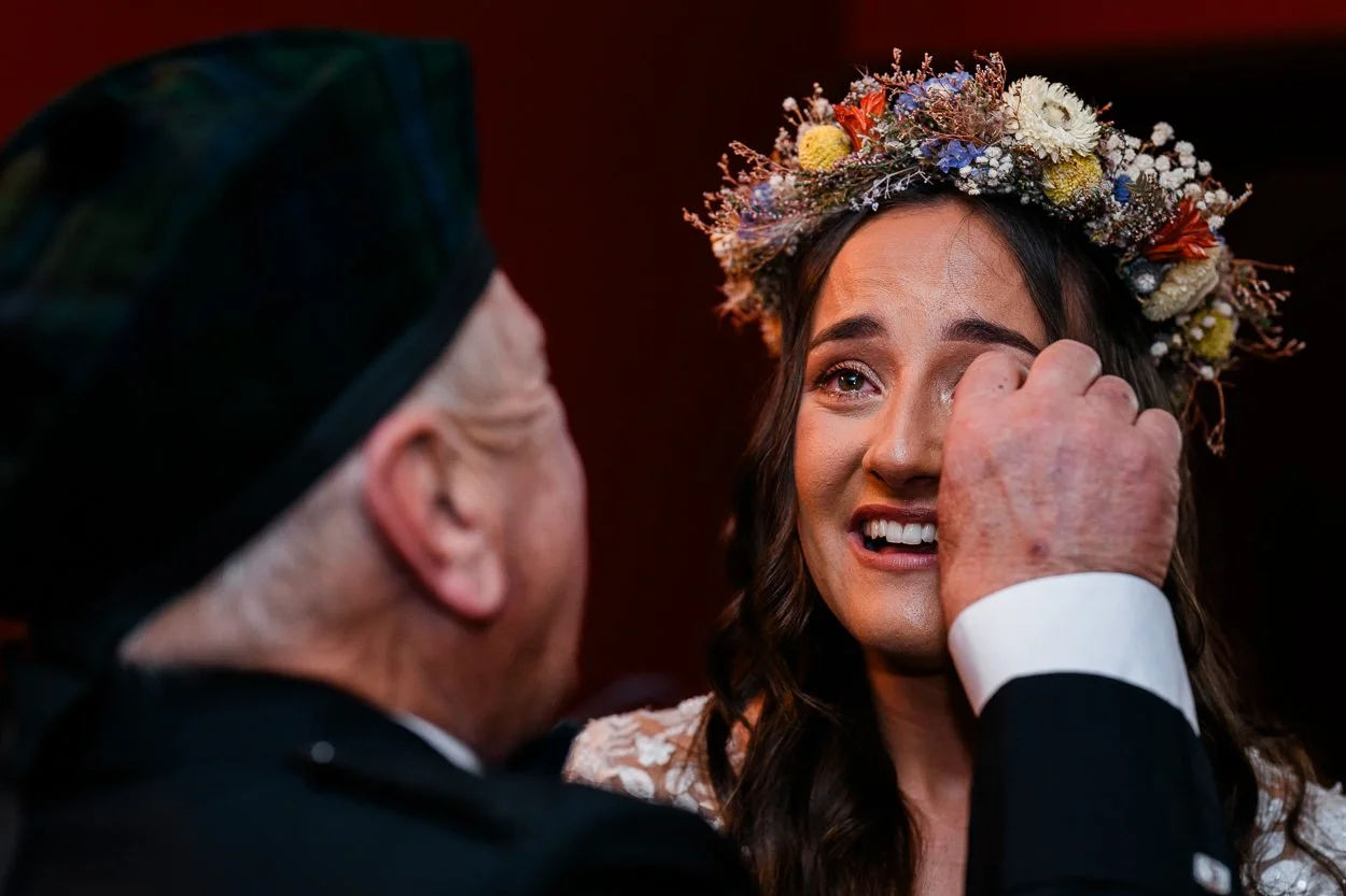 Grandfather-wipes-tears-from-brides-eyes-at-Barcaldine-castle-wedding