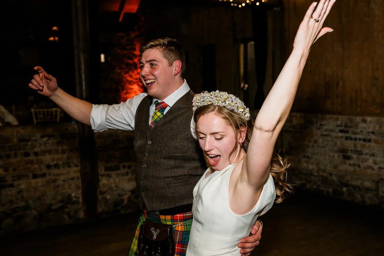 Bride and groom doing wild dancing