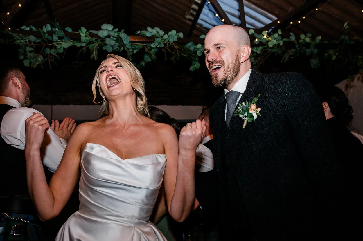 Bride-and-groom-wild-dancing-cardney-steading-wedding