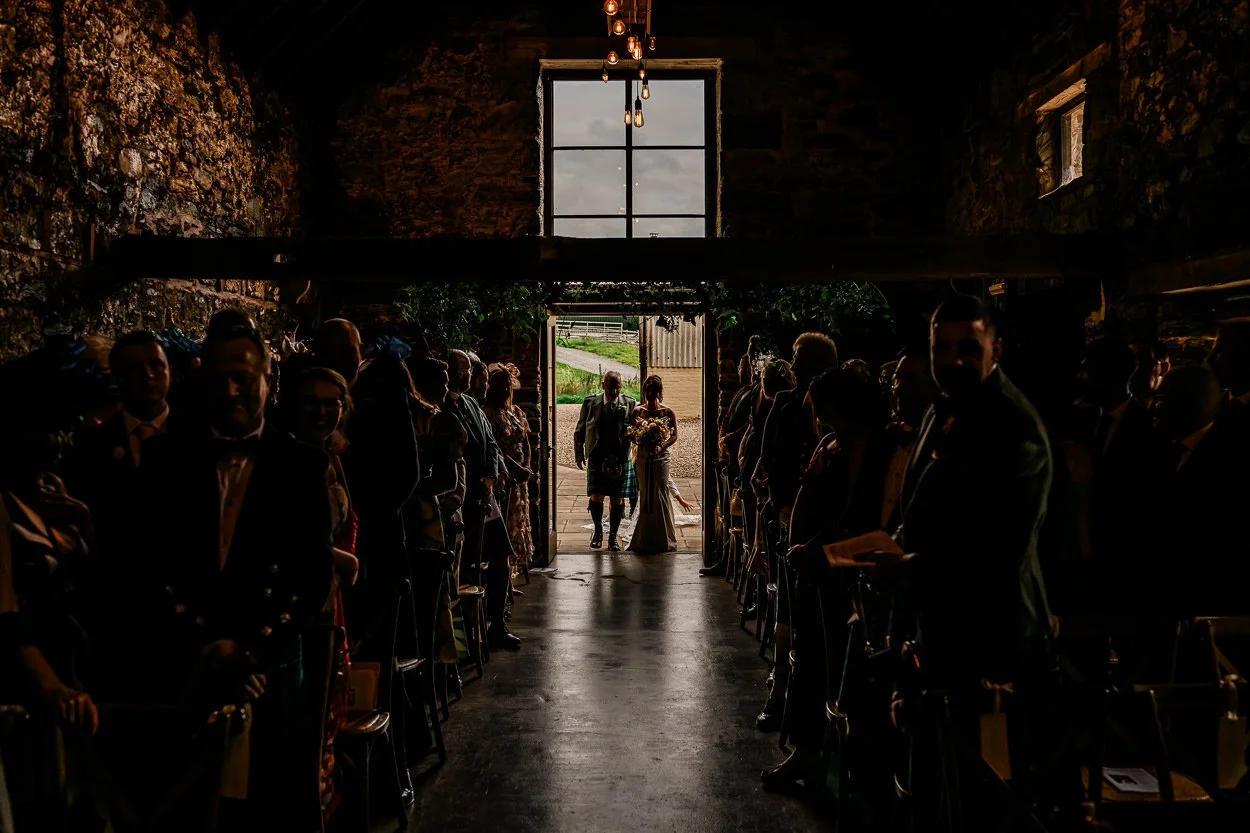 silhouette of bride and father walking down the aisle