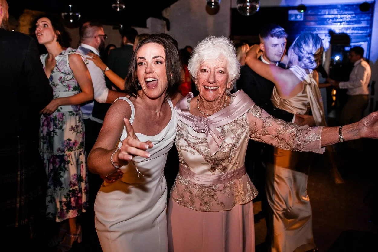 Bride-and-grandmother-dancing-together-at-cardney-steading-wedding