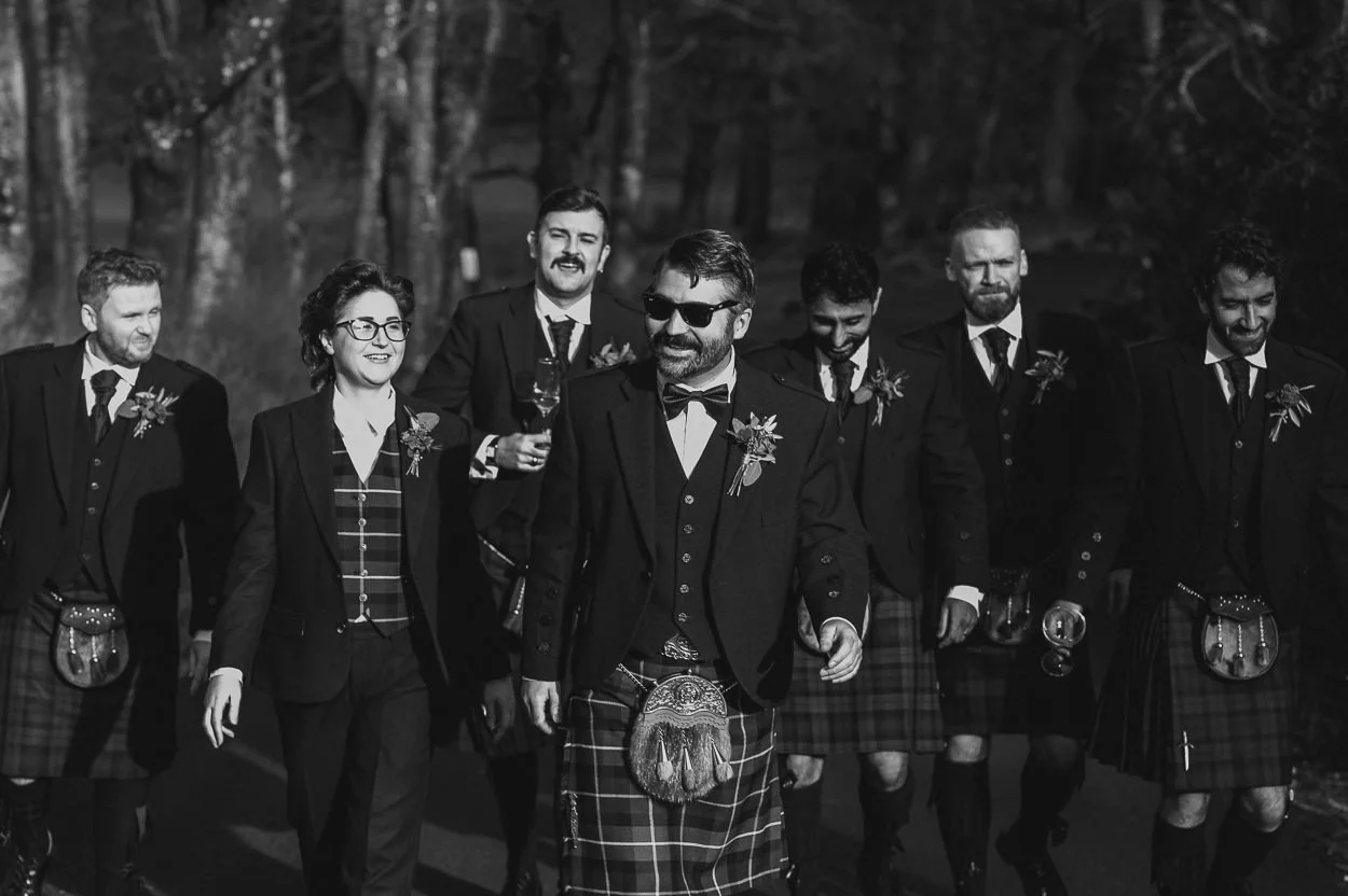 Black and white picture of groomsmen walking 