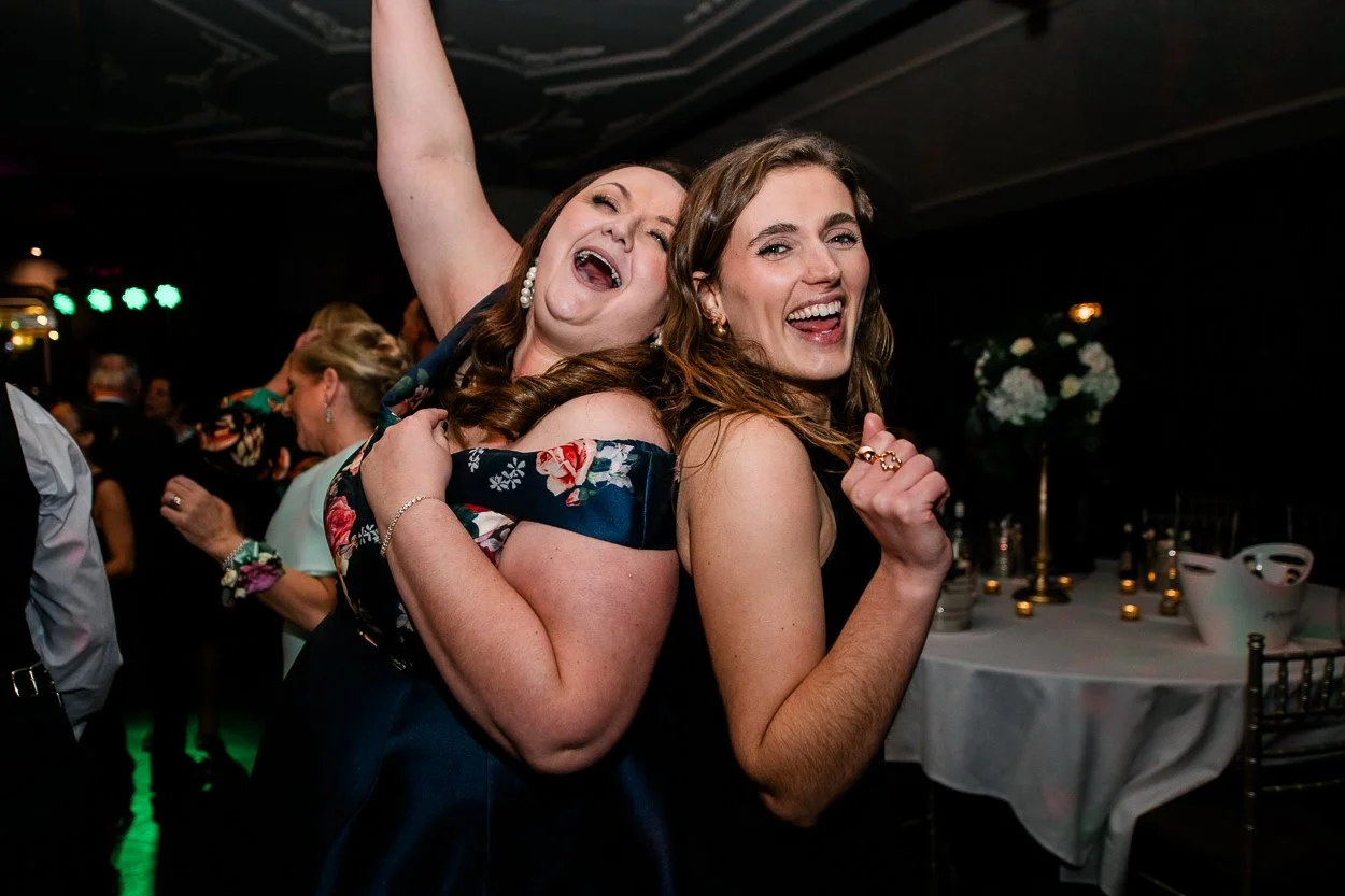 Two guests partying hard on the dance floor at a wedding