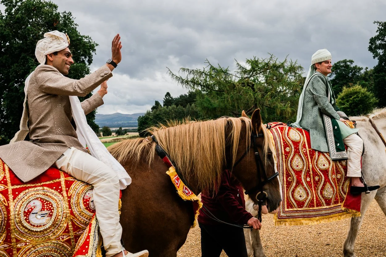 Two grooms arrive to Hindu wedding on horseback 