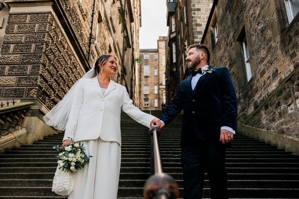 Bride-and-groom-on-historic-stairs-in-Edinburgh