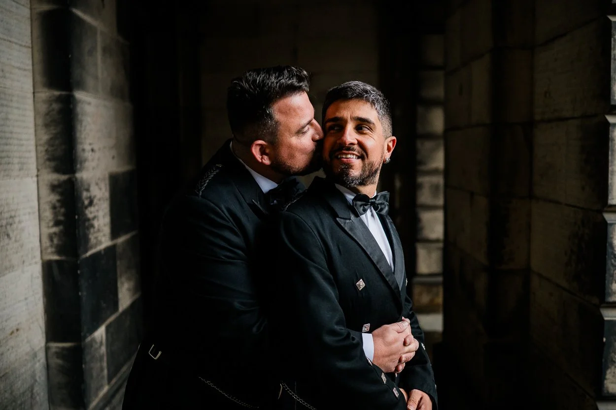 Two-grooms-emotional-embrace-at-Edinburgh-wedding