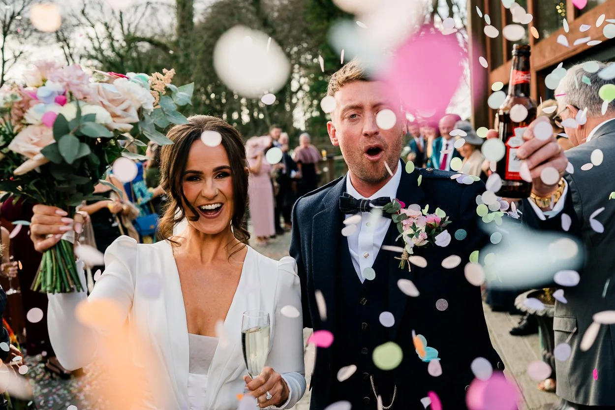 Close-up-of-bride-and-groom-confetti-shot